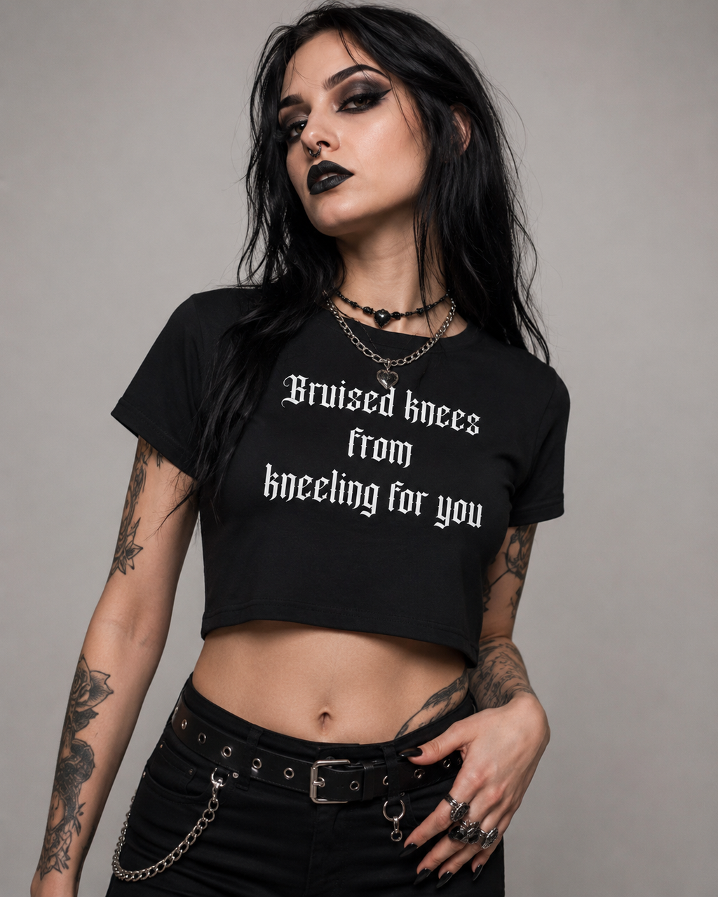 Women's Baby Tee — "Bruised knees from kneeling for you" Gothic Text Crop Top