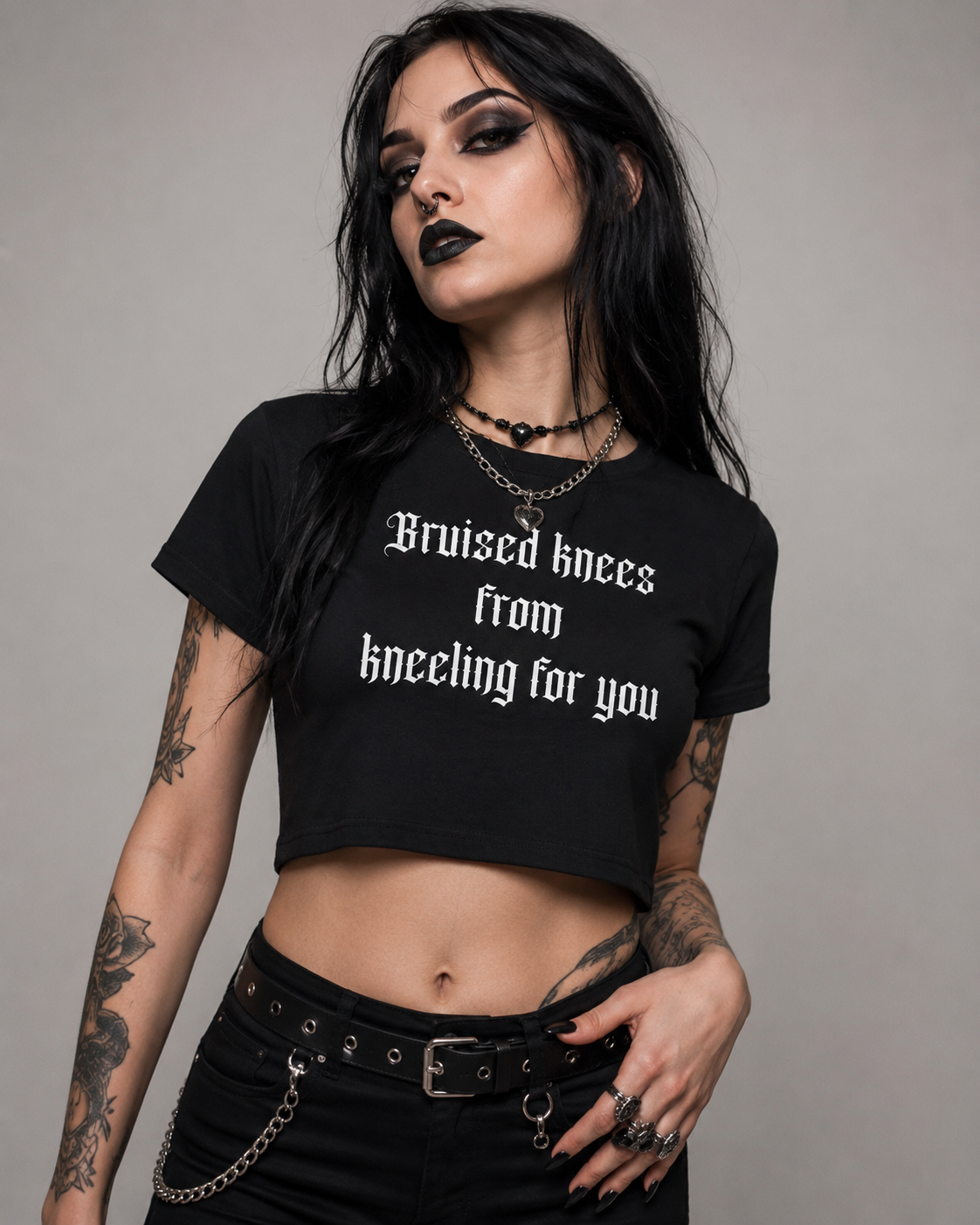 Women's Baby Tee — "Bruised knees from kneeling for you" Gothic Text Crop Top
